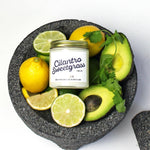 MIni Cilantro Sweetgrass scented soy candle pictured in bowl with lemons, limes, avocado. 